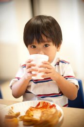 a child drinking from a cup
