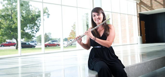 Flautist in music school lobby
