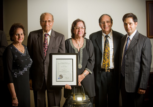 Group photo of Dr. Chopra, his wife and others with certificate