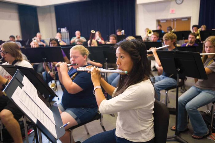 a group of people playing instruments in a room.