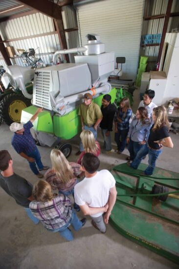 a group of people standing around a machine.