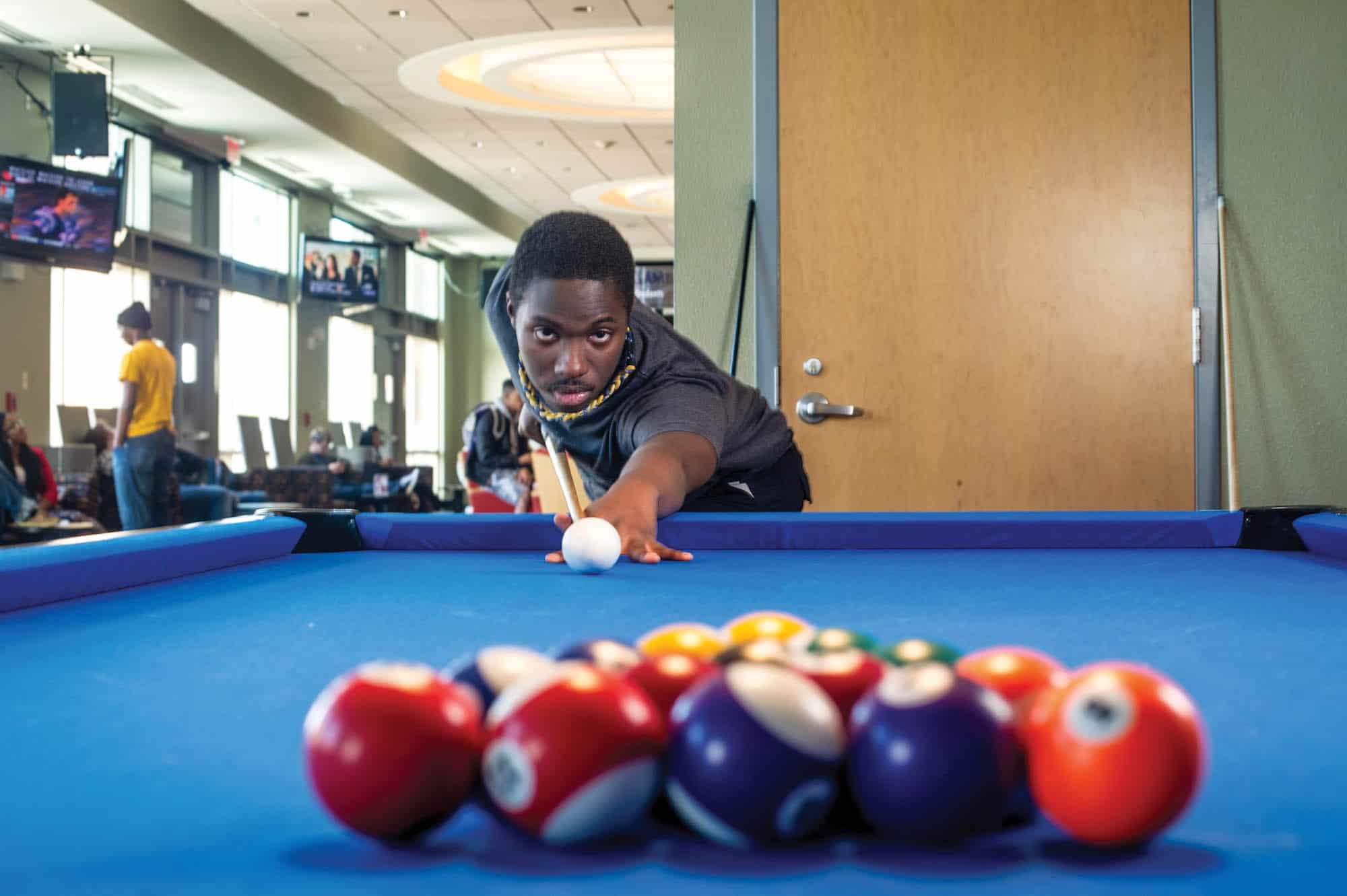 student playing 8-pool