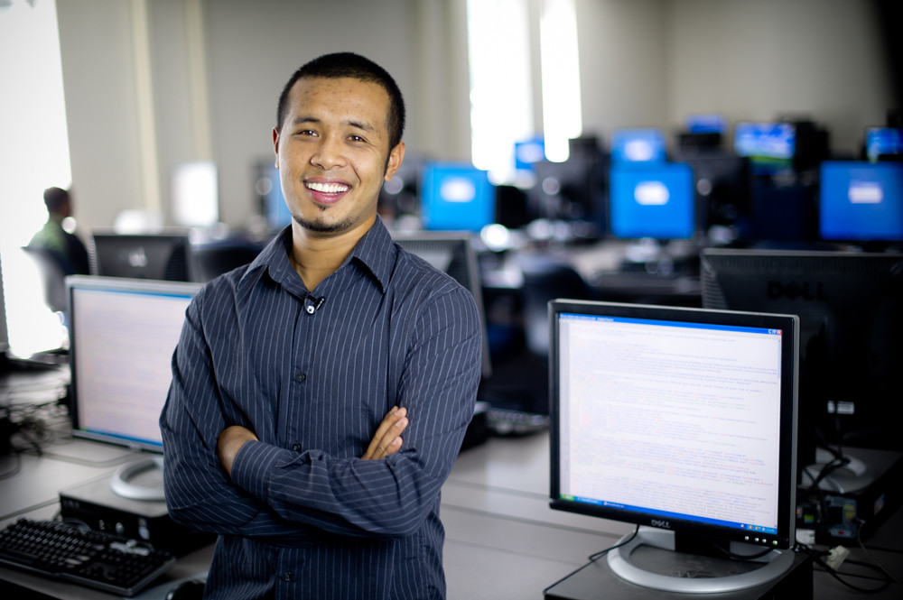 Man standing in front of computers.