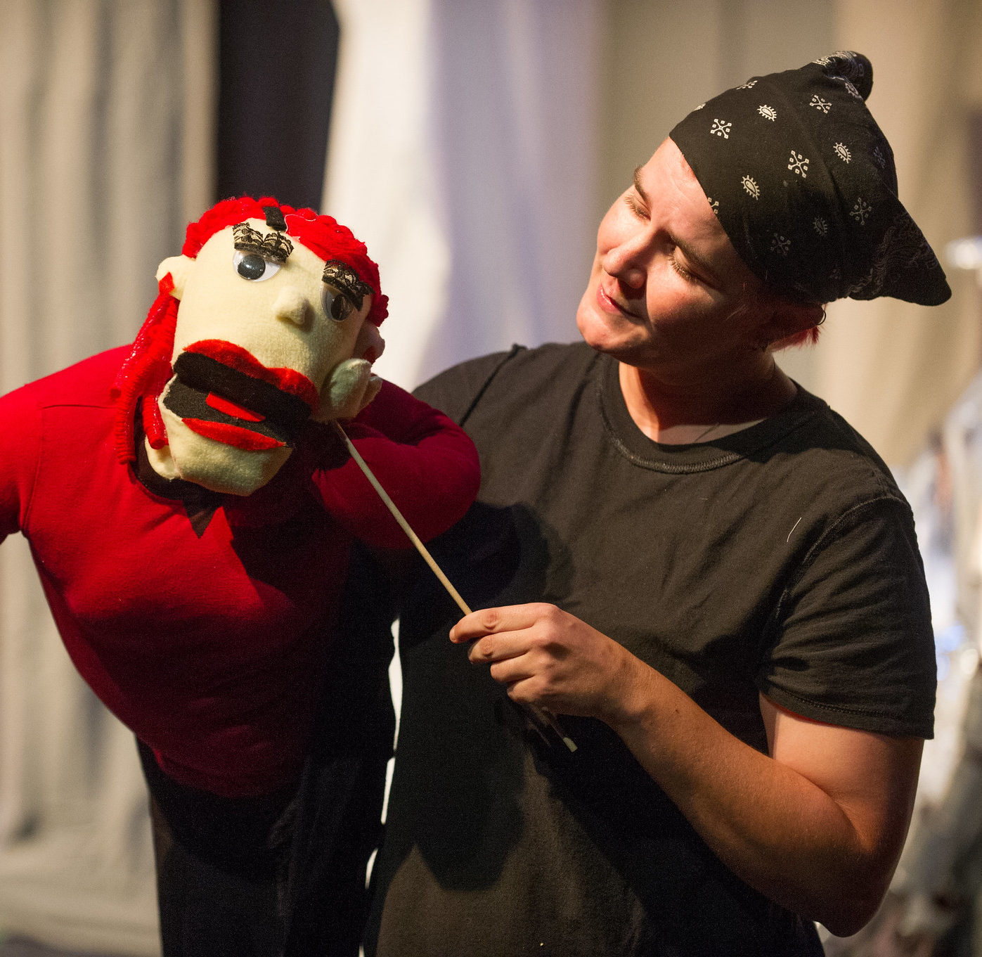 Theatre student performing with a puppet.