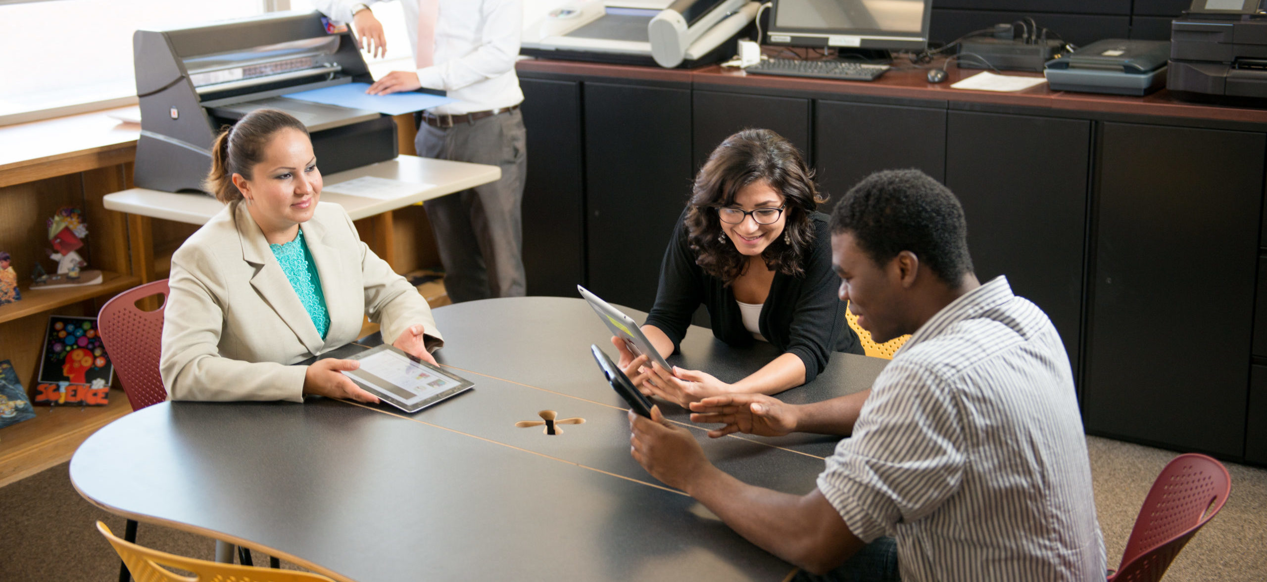 Group of people meeting around a table.