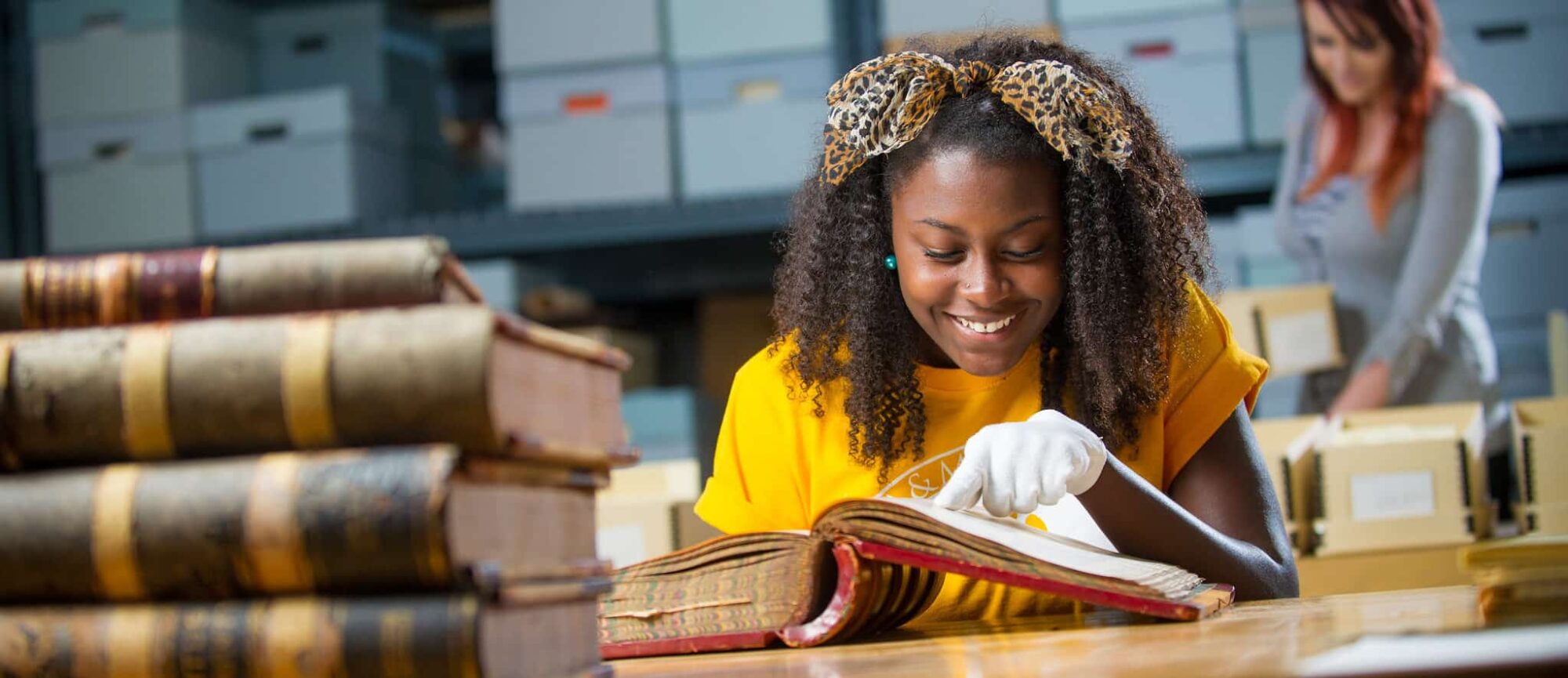 Student examining historic book.