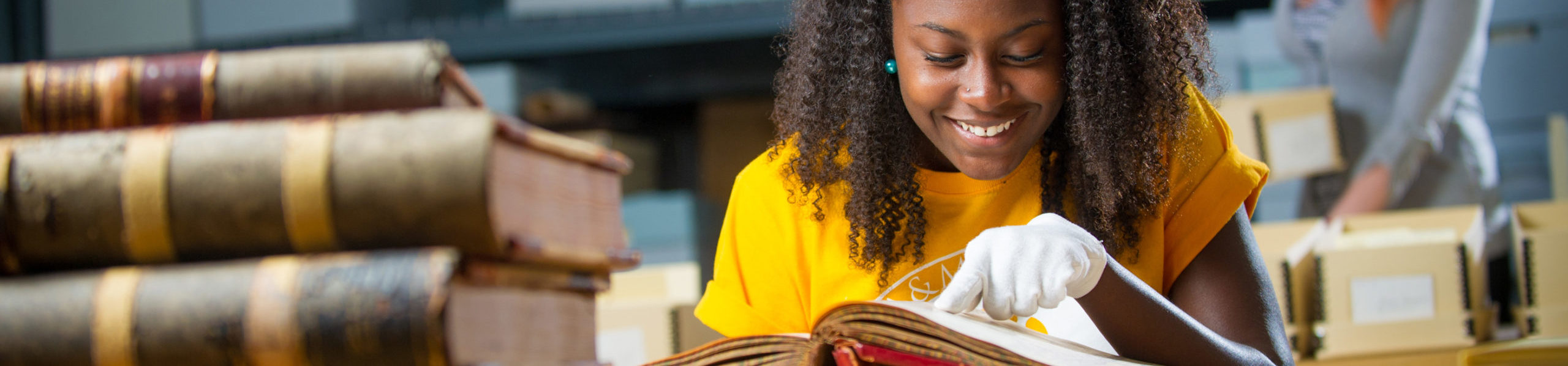 Student examining historic book.