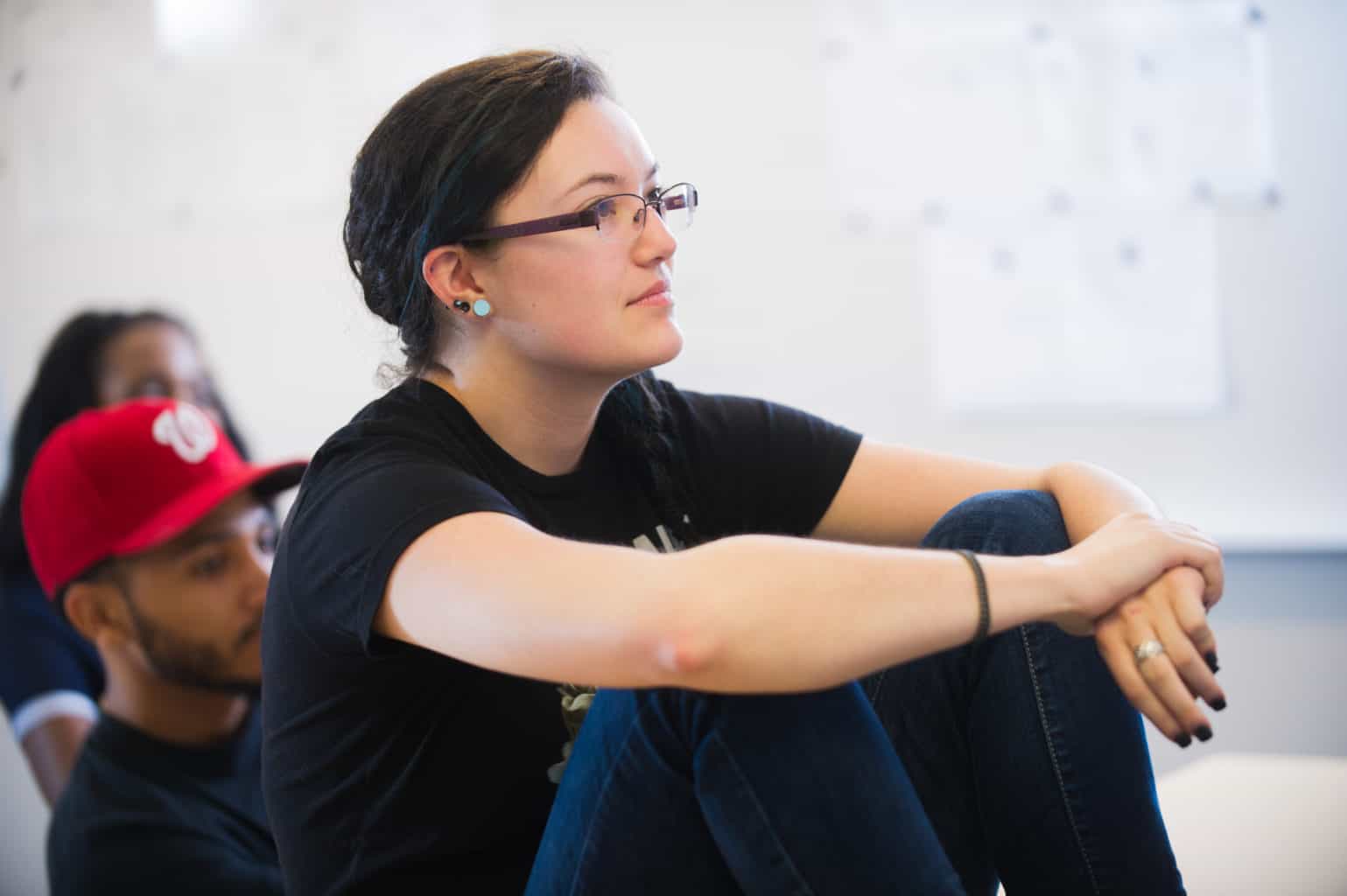 Student sitting on desk listening