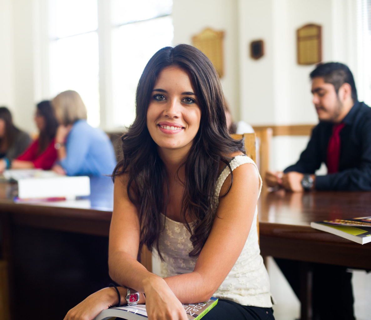 Woman sitting in a spanish classroom.