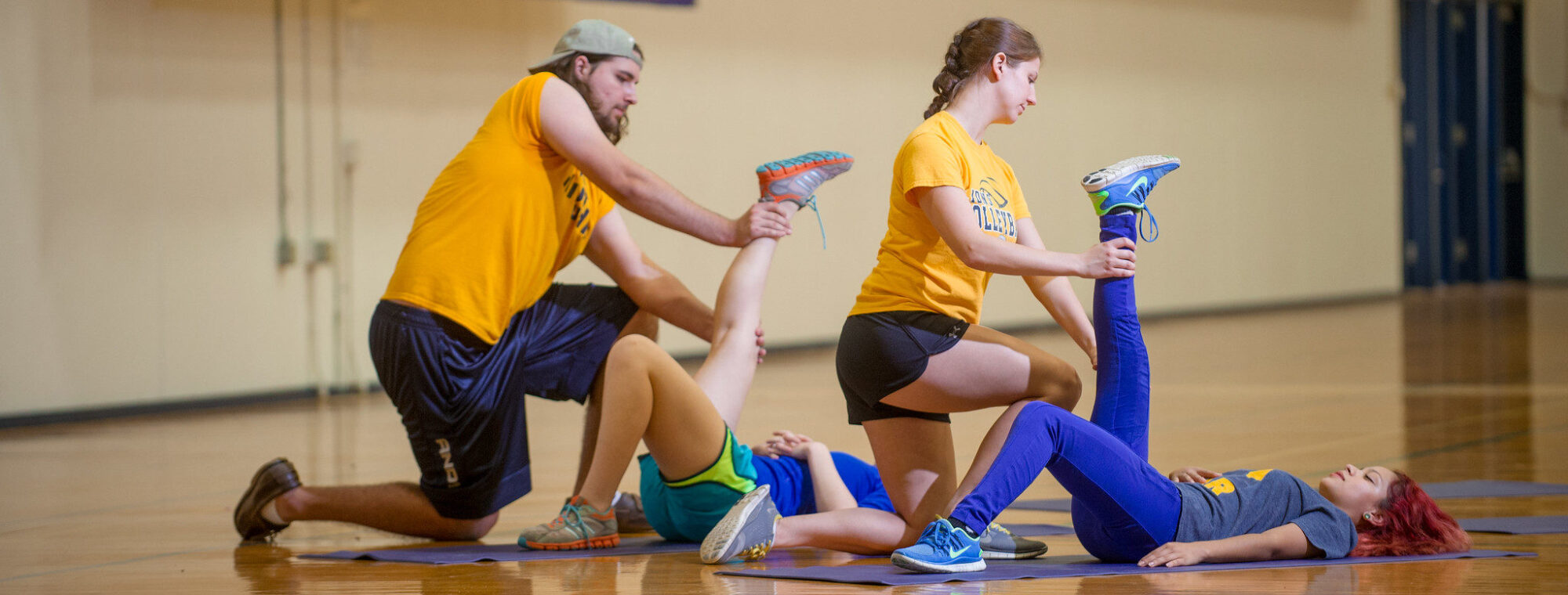 Kinesiology students working with trainers.