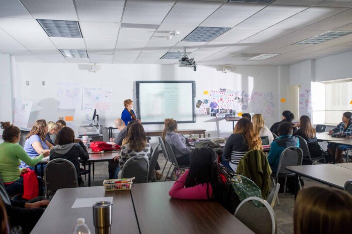 Woman teaching college class.