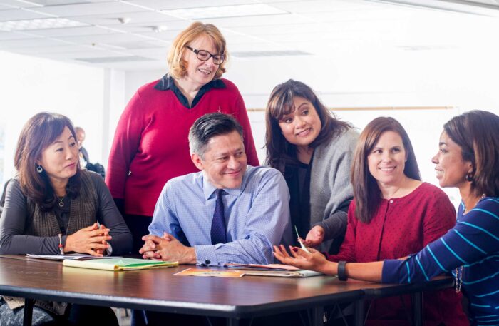 A group of instructors sitting at the table having a conversation.