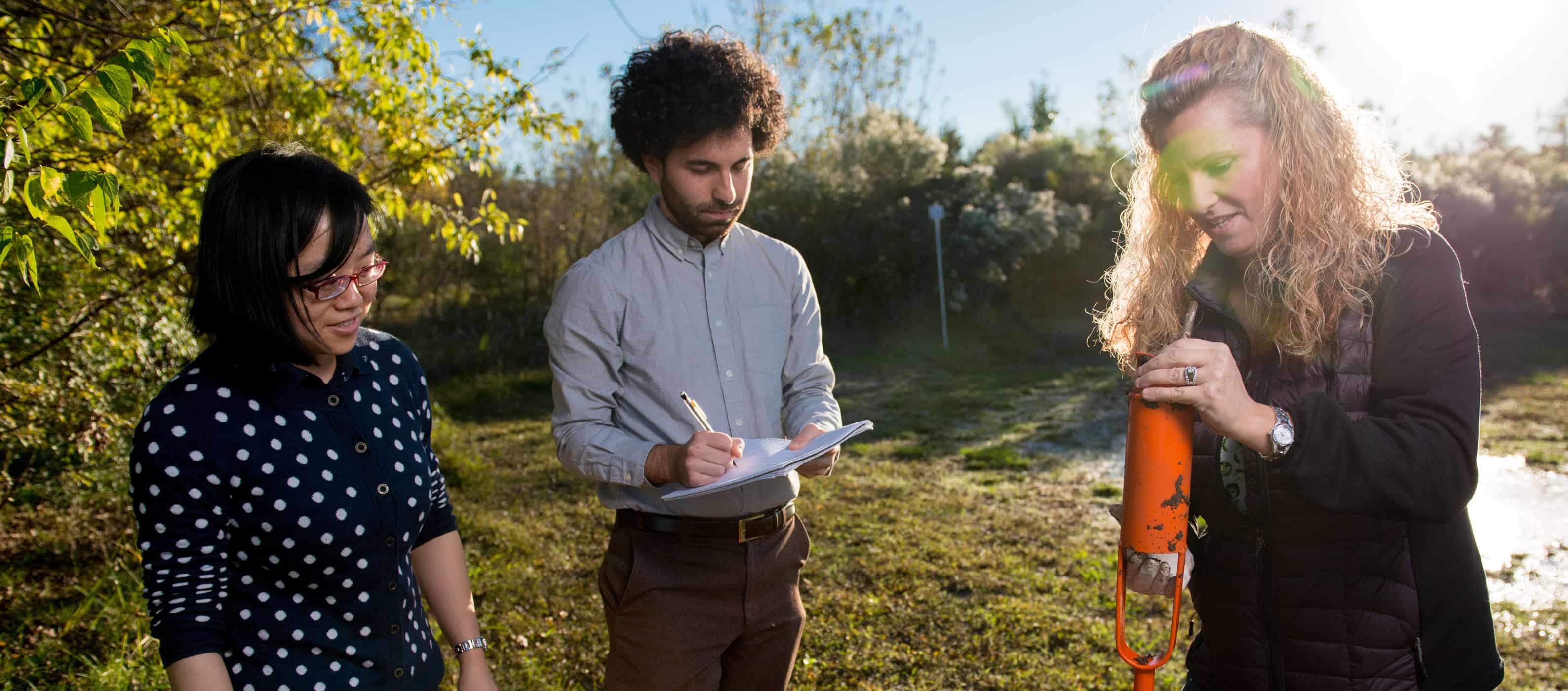 Environmental scientists taking sample in a field