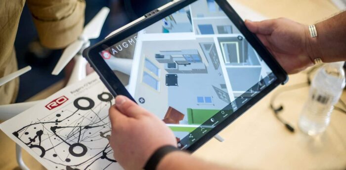 Virtual birds eye view of a floor plan displayed on a tablet.