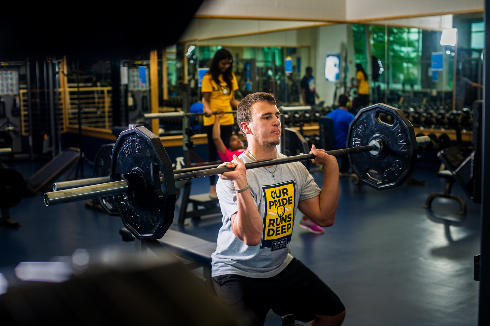 Male student power lifting in rec center