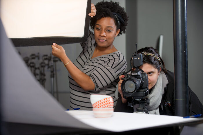 two young females working together on a shoot.