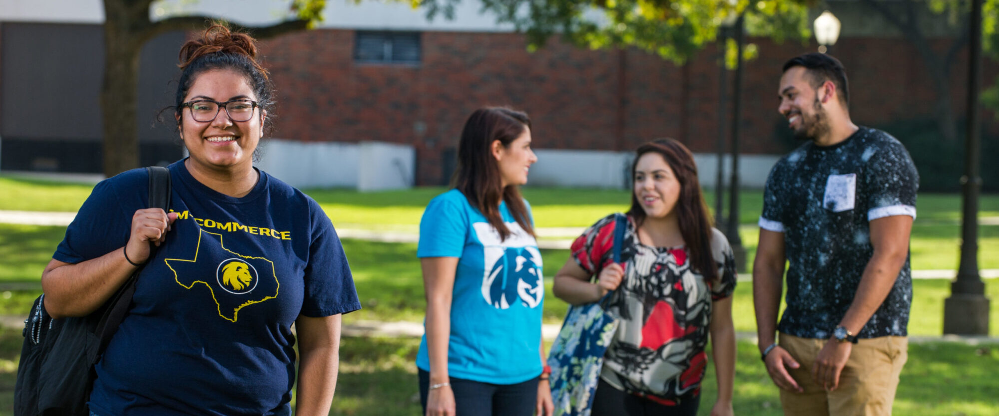 Diverse group of students with female student looking directly at camera.