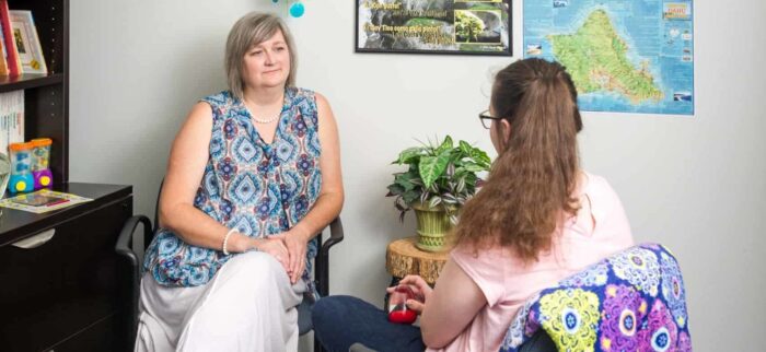 Two women sitting in counseling session.