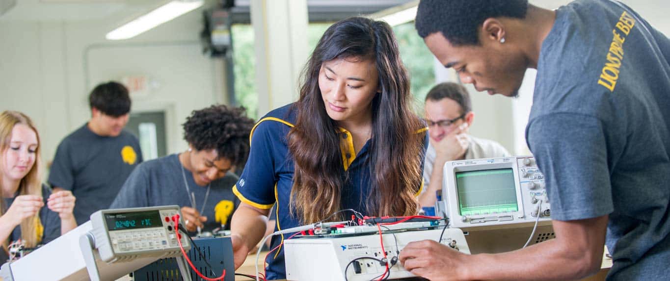 Engineering students working with equipment