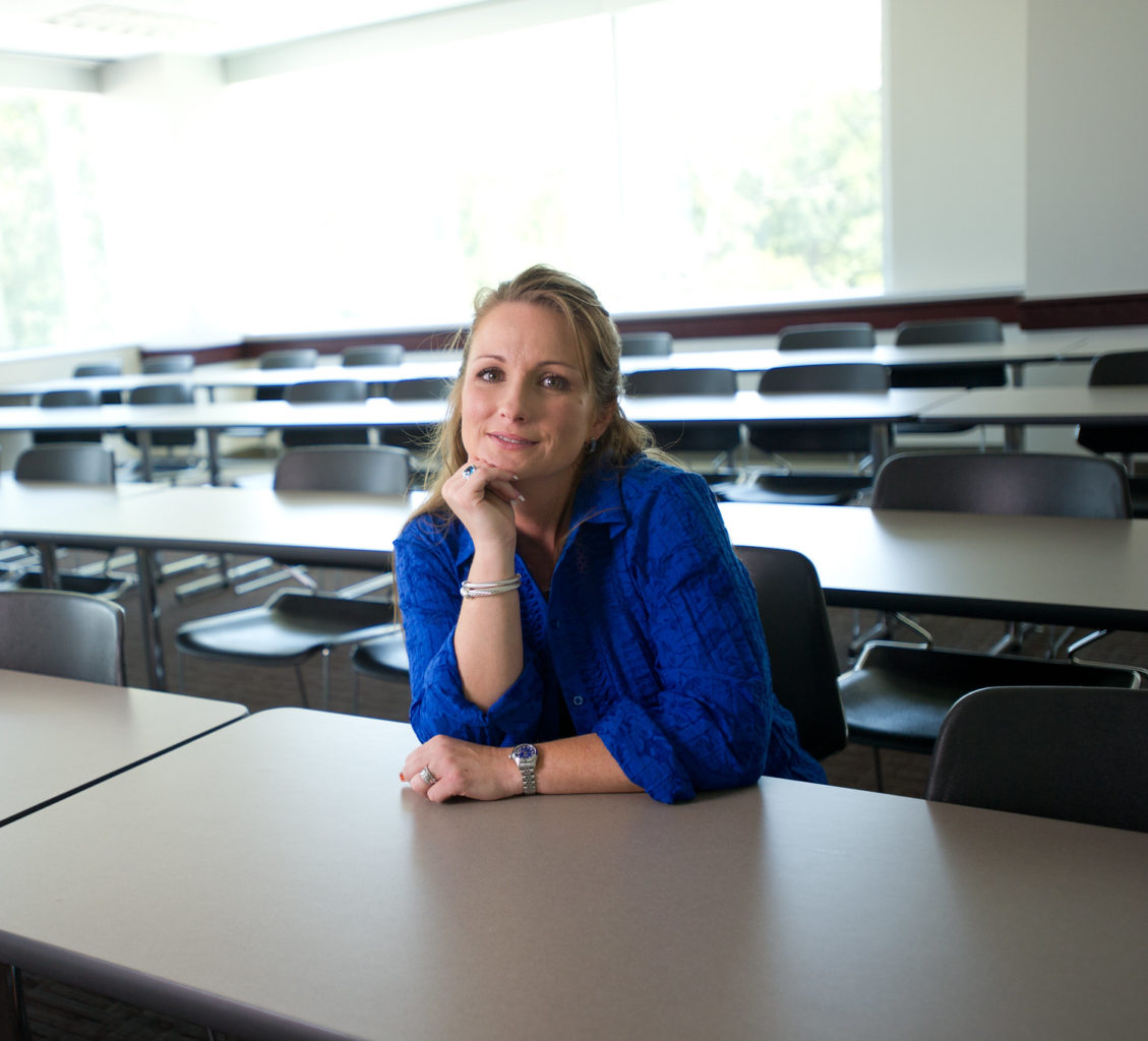 Higher education student sitting in a classroom.