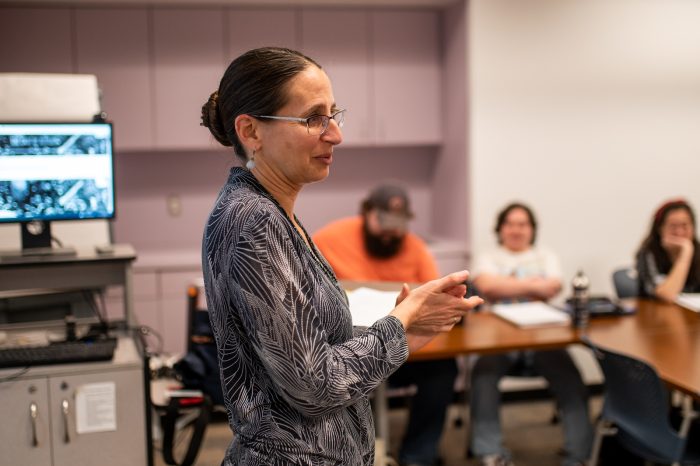 A female professor lecturing during class.