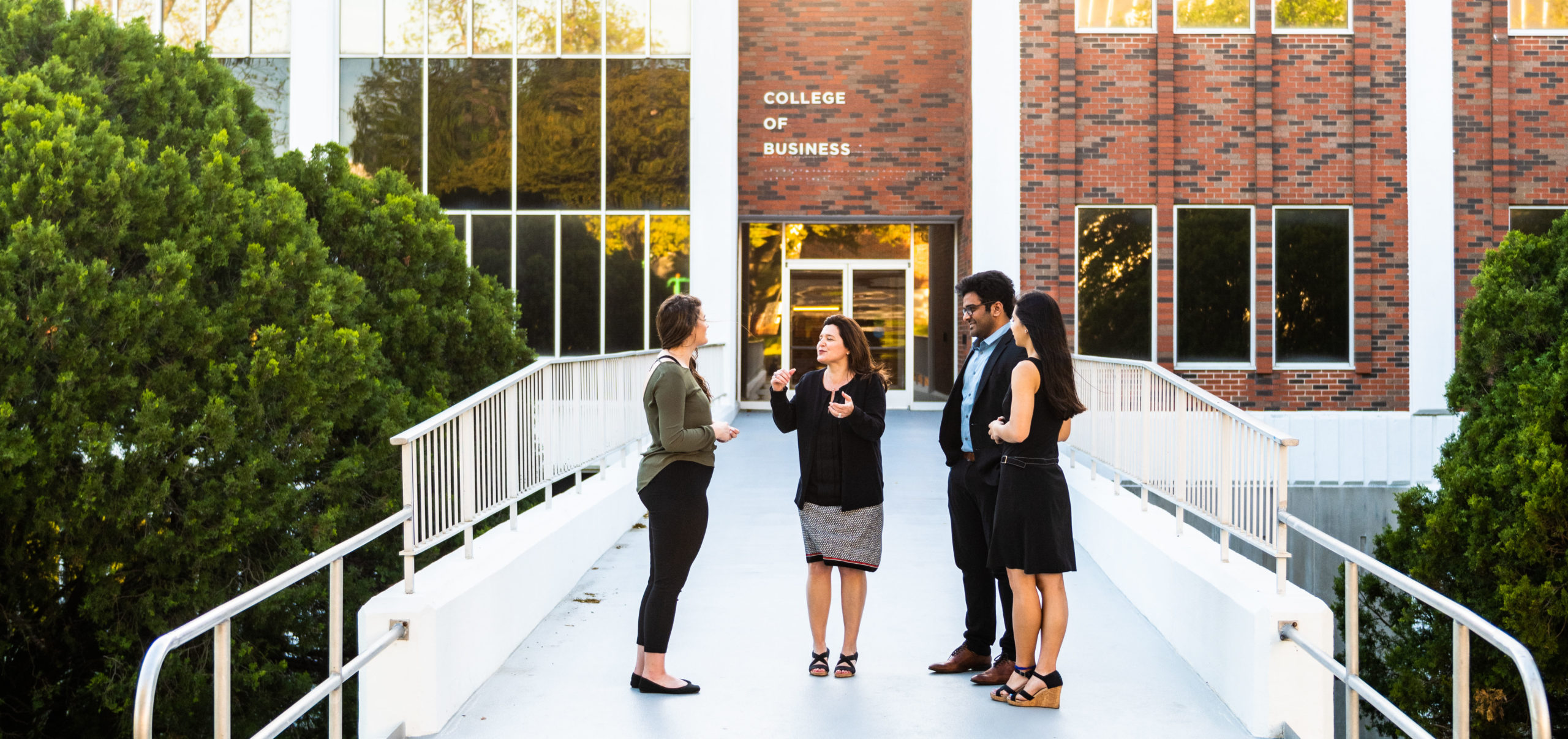 Group standing in front of the College of Business.