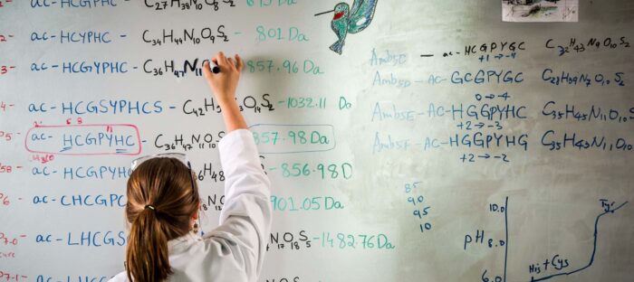 Chemist writing chemical formulas