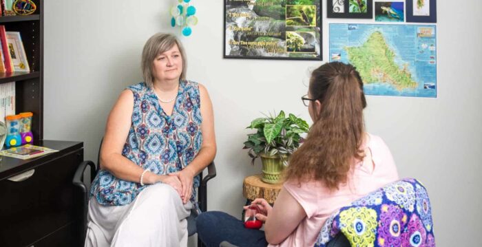 Two women sitting in counseling session.