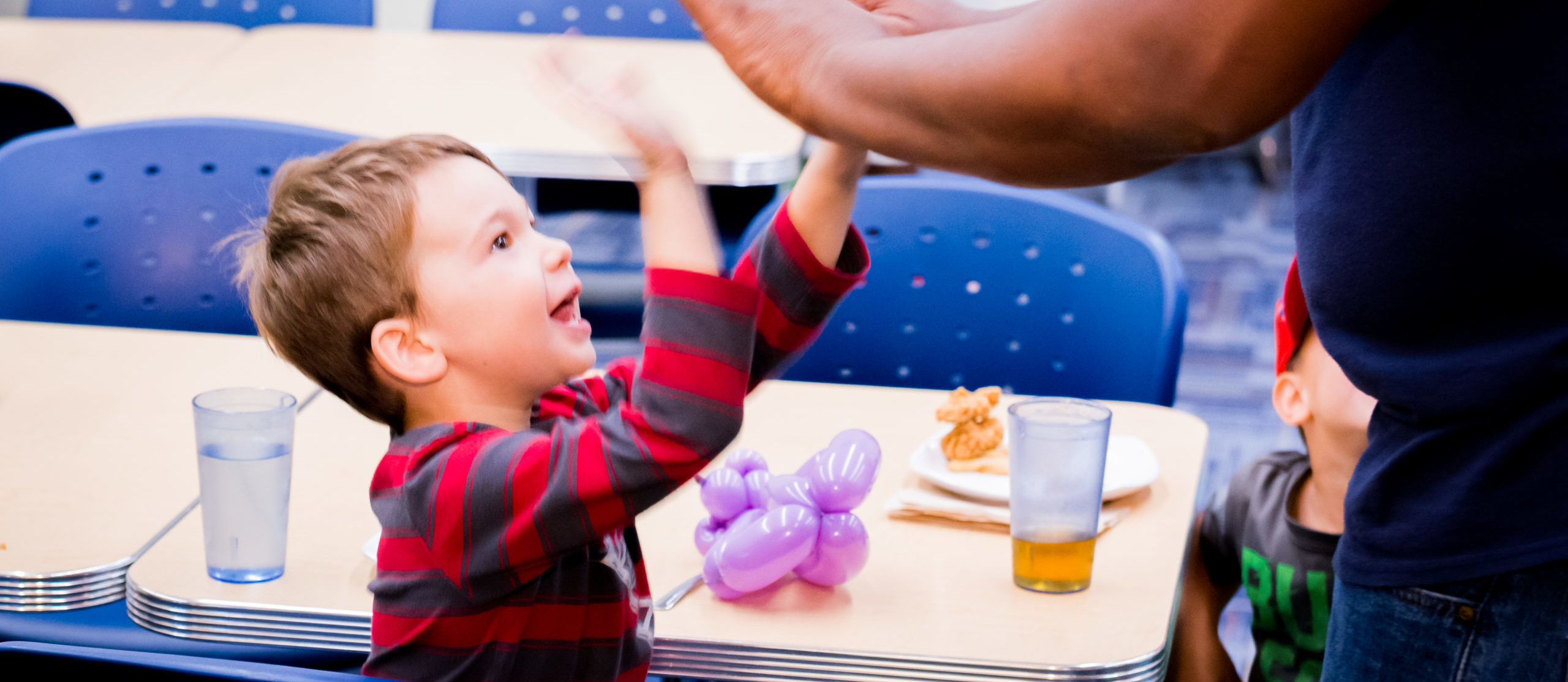 Child and social worker at a table.