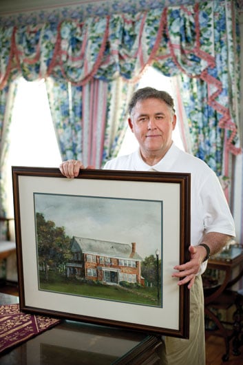 Ted Crim holding Heritage house frame