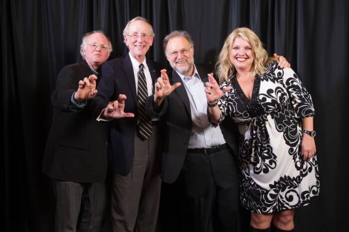 Ben ,jerry and other professors showing cross sign