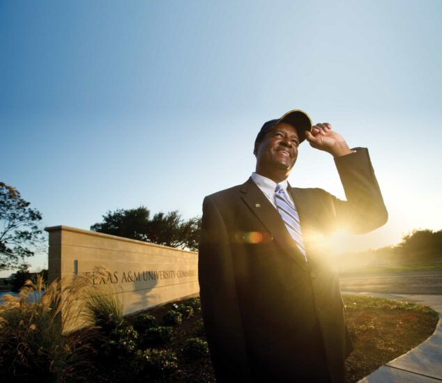 Stan McKee with cap background Texas A & m commerce entrance and sunshine