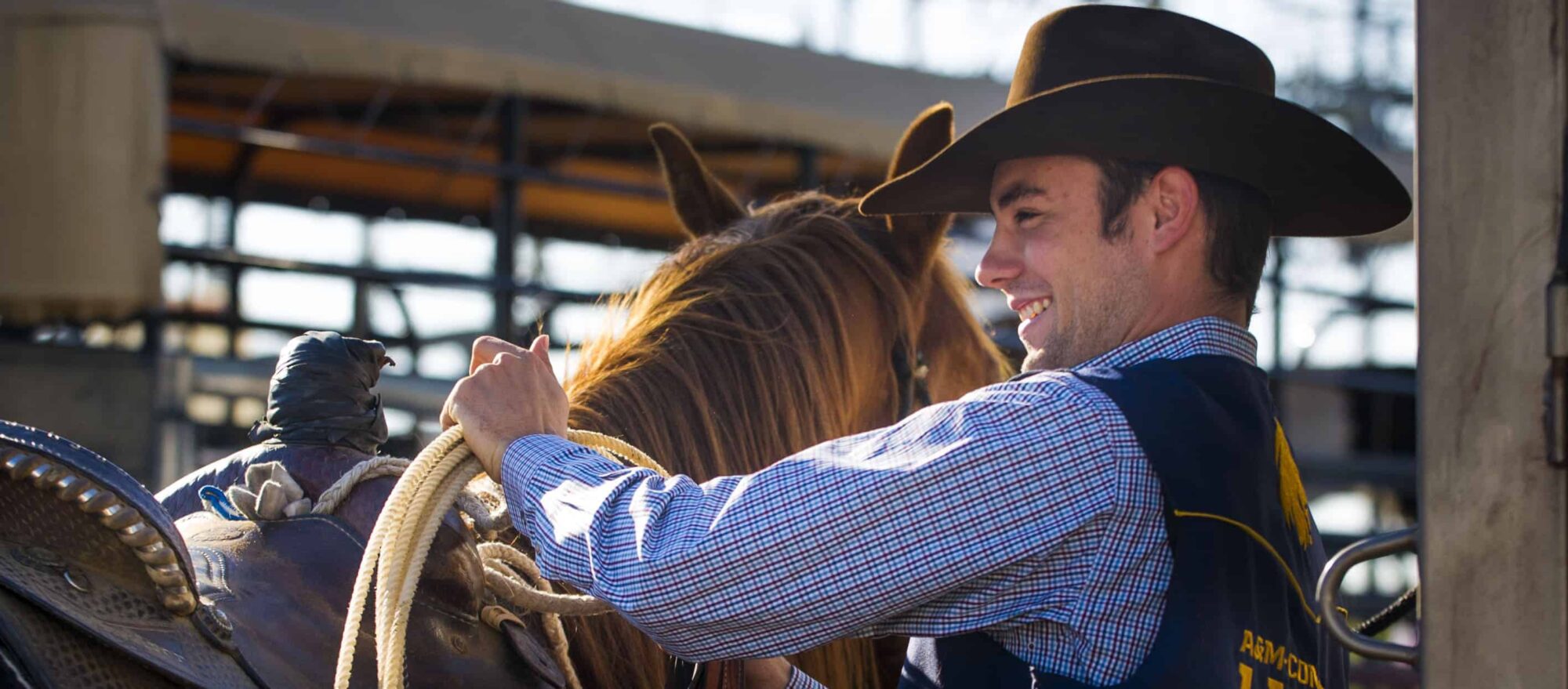 Member of the rodeo team beside his horse.