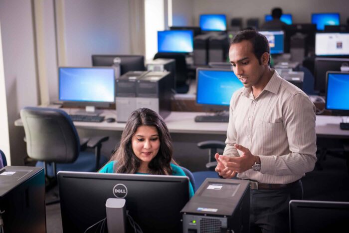 Computer science instructor helping student