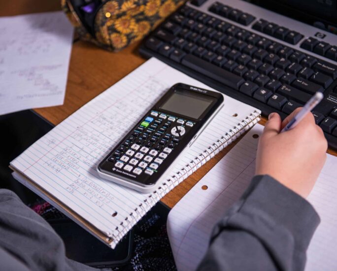 Close-up of student working on math homework