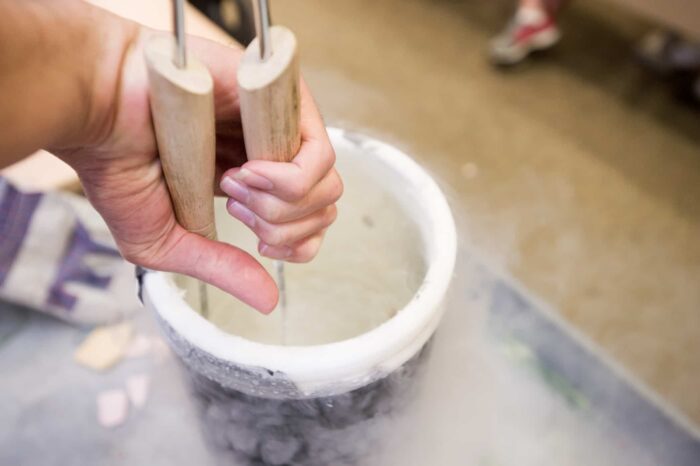 Tongs inserting container of liquid nitrogren