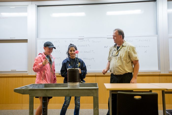 Instructor and students perform experiment