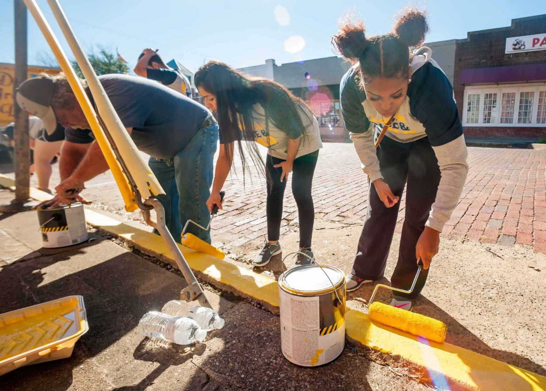 Students painting foot path