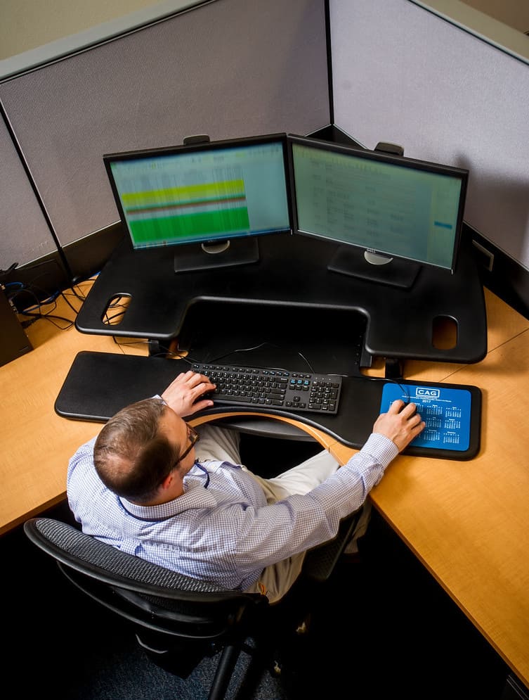 Computer scientist working at several monitors