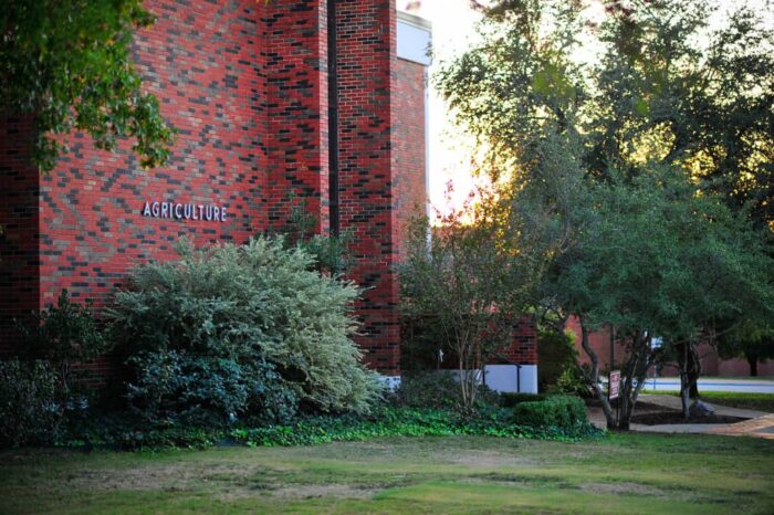 The Agriculture building with vegetation around it.