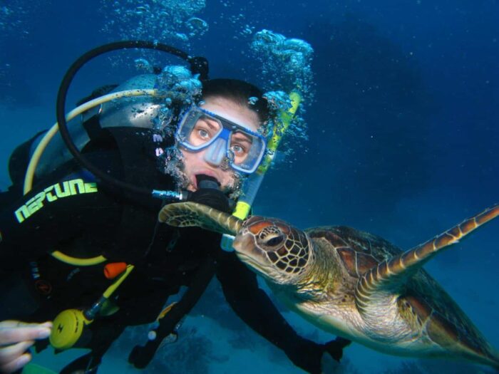 Women inside water with a tortoise