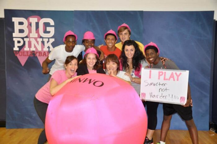students with big pink ball and one student holding board 'I play smarter not harder!!'