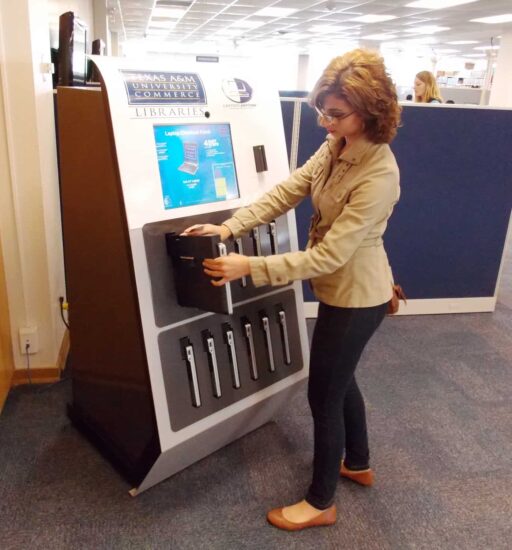 student taking laptop from the laptop machine