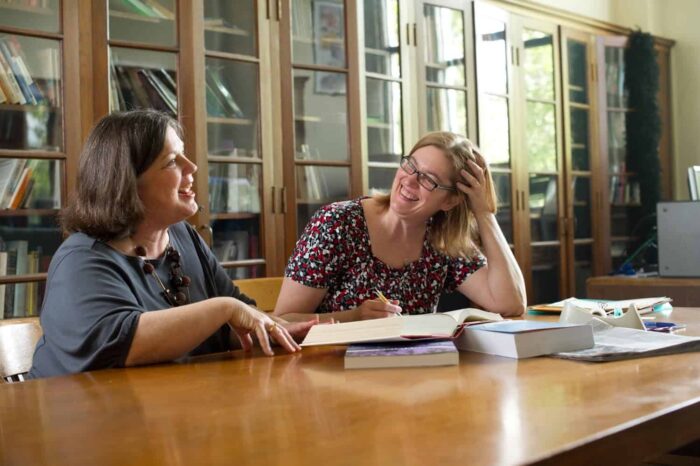 Two persons interacting in library