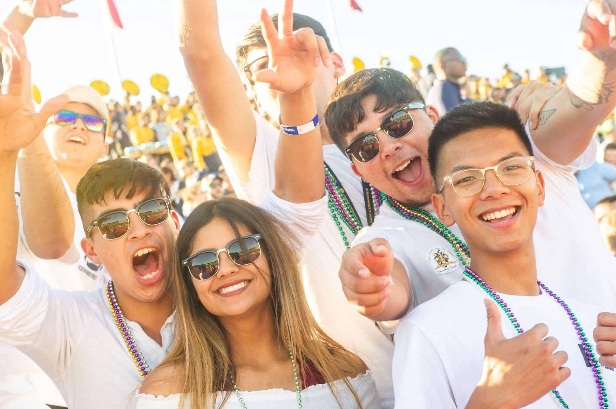 A group of student wearing sunglasses and celebrating homcoming.