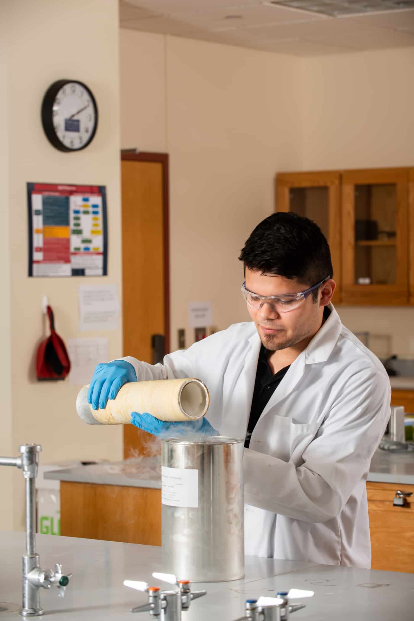 Chemist pouring liquid nitrogen into a container