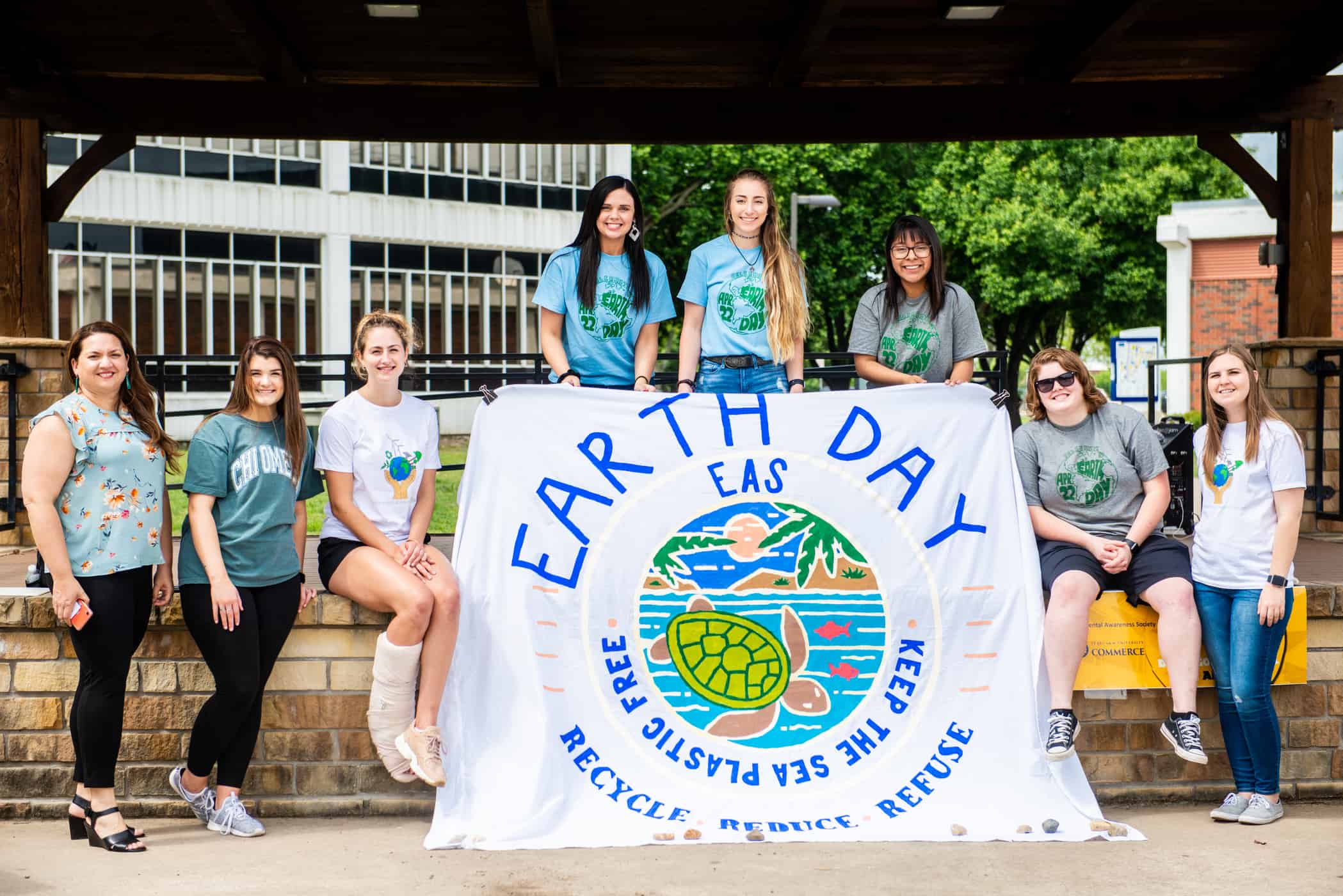 EcoLions students holding Earth Day banner