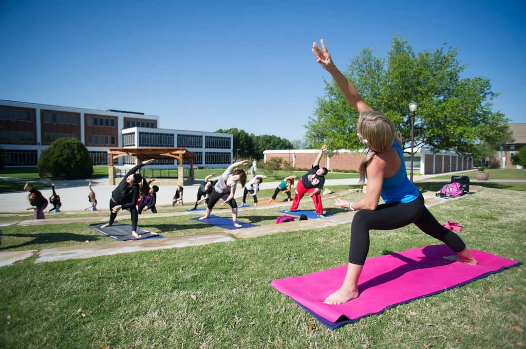 A group of students during a yoga session taught by another student.