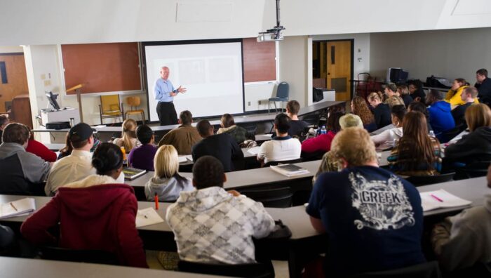 Instructor teaching in front of class.