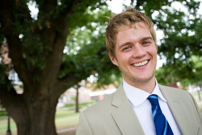 Student smiling background tree